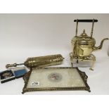A brass and glass tray a brass trivet kettle and a