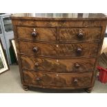 An Early Victorian mahogany bow fronted chest of drawers fitted with two short and three long