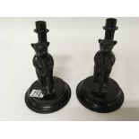 A pair of cast metal bear shaped candle sticks. (2