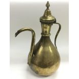 An early 20th Century Islamic brass teapot, approx height 38cm.