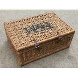 A wicker F&M Hamper basket