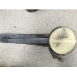 An open backed five string banjo with carry case -