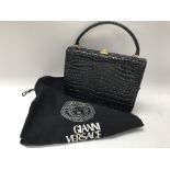 A Giani Versace crocodile black clutch bag, includ