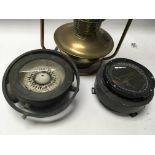 Two Military type compass on e in a gimbal pattern
