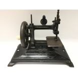 A small cast iron Victorian sewing machine.