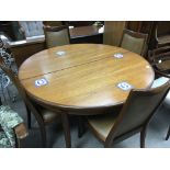 An Ercol round modern design extending dining tabl