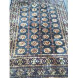 A hand knotted rug with a geometric gold pattern o