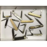 A collection of vintage pocket knives including mo