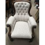 A Victorian rosewood open arm chair with button ba