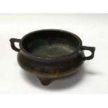 A small cast bronze incense burner with impressed