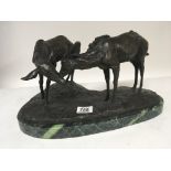 A 20th century bronze in the form of two Fallow deer on a green marble base. Signed Height 22cm.