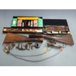 A collection of shotgun parts including stocks, locks etc together with three shotgun cleaning kits,