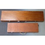Two shotgun cases, one with fitted interior and metal bound corners (82 x 23 x 8.5cm) the other
