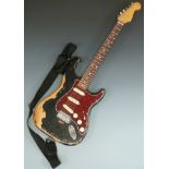 Stratocaster style electric guitar in black finish with red pearloid finger plate, 'well gigged'