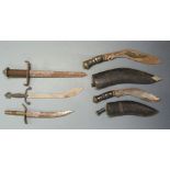 Five daggers including two kukris both with sheaths, largest with 29cm blade. PLEASE NOTE ALL BLADED