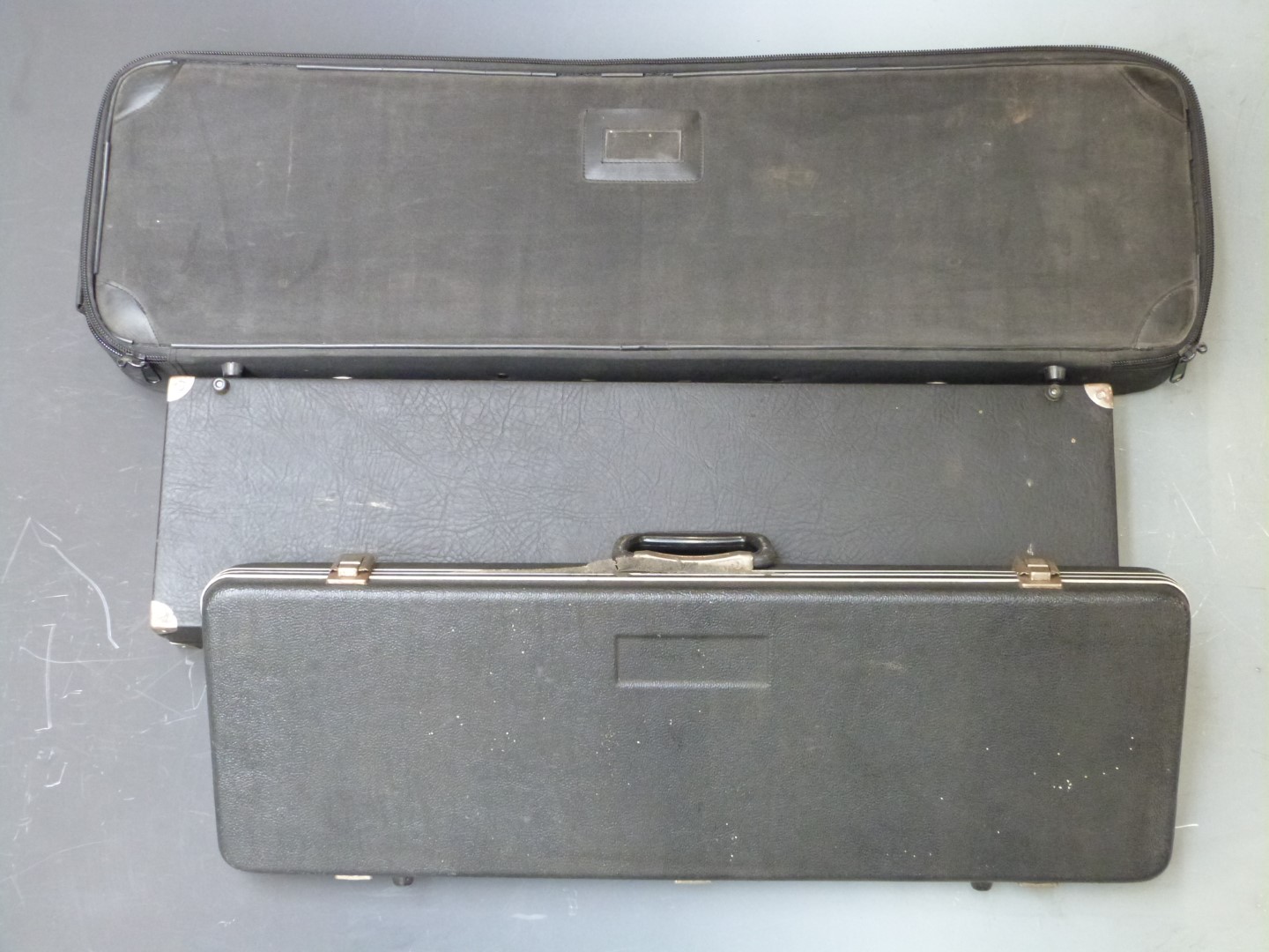 Three shotgun or rifle carry cases, largest 96 x 28 x 11cm.