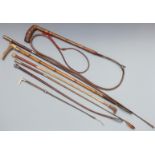 A collection of vintage riding crops, whips and sticks including hallmarked silver mounted examples