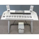 Yamaha Tyros 2 digital workstation / keyboard / electric piano on stand together with a Yamaha