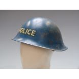 British steel Police helmet together with an earlier Home Front example
