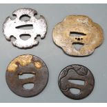 Four Japanese Samurai sword tsuba, some with pierced and gilt decoration, largest 8.5cm in diameter.