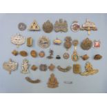 Collection of military badges including Royal Irish Rifles, Gloucestershire Regiment and Royal