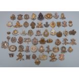 Approximately fifty British Army cap badges including Notts & Derby Regiment, Leinster Regiment,
