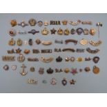 Collection of military badges and shoulder titles including Royal Navy, Royal British Legion,