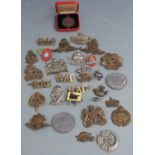 Small collection of British Army cap badges including Leinster Regiment, Tank Corps, Royal Artillery