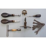 Seven various gun tools including nipple keys and wrenches, multi-spanner set, spring clamp etc.