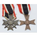 Two German WW2 Third Reich Nazi War Merit Cross medals, one Second Class with crossed swords, the