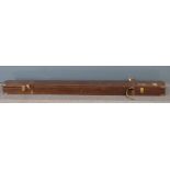 A leather and brass bound wooden fishing rod box with leather straps and key, L196cm