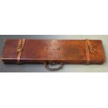 Leather gun case with fitted interior and brass lock, 82x21.5x8cm.