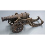 A cast iron signalling or desk cannon with 10 inch graduated barrel, overall length 42cm.