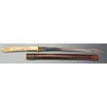 Burmese dha ivory handled sword circa 1900, with ornate carved grip, 54cm plain blade and leather