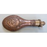 Copper and brass powder flask with embossed decoration of horses to both sides, 21cm long