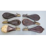 Six leather shot flasks some with embossed decoration and belt loops, one Dixon & Sons, largest 25cm