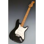 Stratocaster style electric guitar in black glitter finish with white finger board, in soft Fender