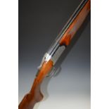 Browning Medalist 12 bore over and under ejector shotgun with named and ornately engraved lock,