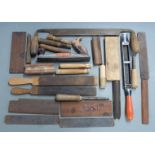 A collection of gun related tools including polishing rasps, barrel polishing blocks, pinfire