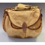 Vintage wicker fishing creel with external canvas and leather pockets.