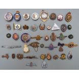 Approximately forty Armed Forces metal and enamel badges and brooches including Royal Air Force,