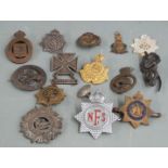 Fourteen military pin back badges including hallmarked silver Army Service Corps, South Wales