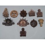 Ten British / Colonial Forces badges, seven being economy issue including Intelligence Corps,