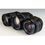 Three Vivitar SLR camera lenses comprising 28mm 1:2.0, 135mm 1:2.8 62mm and 135mm 1:2.8 55mm