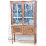 Edwardian astragal glazed mahogany display cabinet with cupboard under, raised on squared tapering