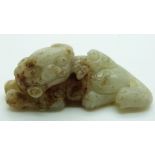 Chinese carved celadon and russet jade Dog of Fo, 2.6x7cm