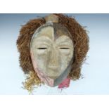 African tribal carved Bakongo mask with raffia and cloth decoration, H27cm