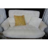 Laura Ashley cream button back two seat sofa raised on turned legs and brass castors, W146cm