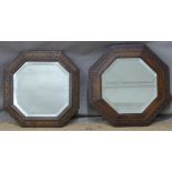 Two octagonal bevelled glass mirrors with carved oak frames including one with Greek key design,