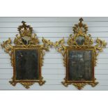 A pair of 18thC Italian Rococo giltwood framed mirrors with silvered glass and arching finials, W100